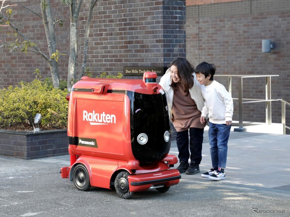 配送先にUGVが到着し、商品を受け取るユーザー《写真提供 パナソニックホールディングス》
