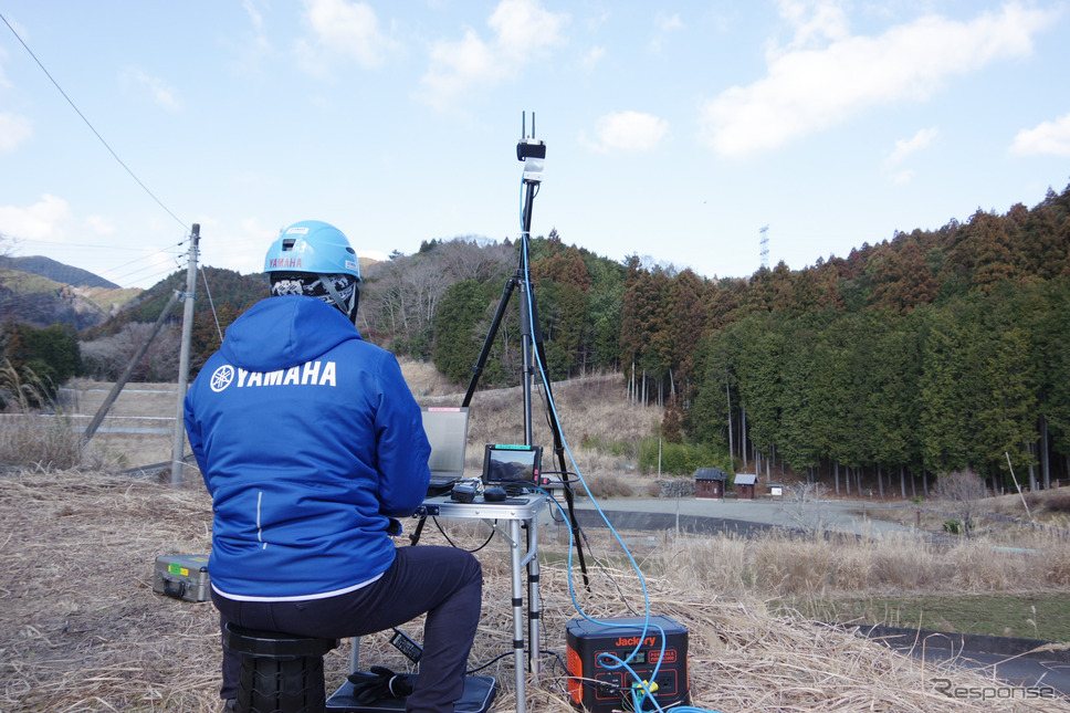 写真中央右の小さな点が、自動航行中の無人ヘリ。常にパイロットがモニターする。《写真撮影 宮崎壮人》